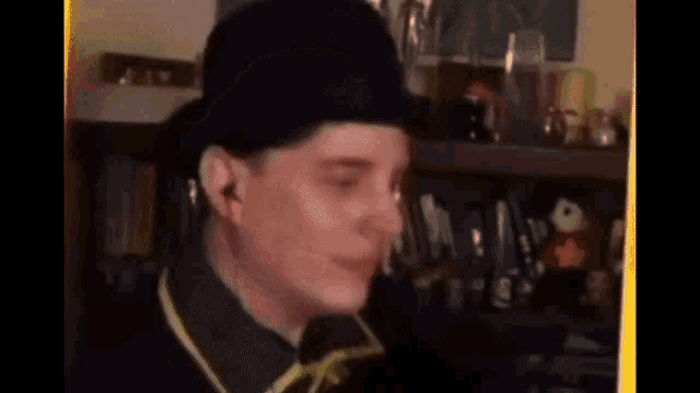 a man is wearing a black hat and a yellow shirt