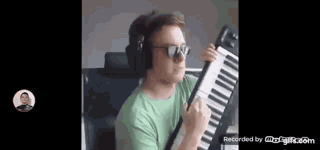 a man is wearing headphones and sunglasses while playing a keyboard .