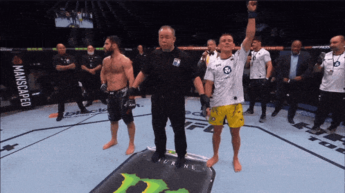 a referee stands in front of a monster energy sign
