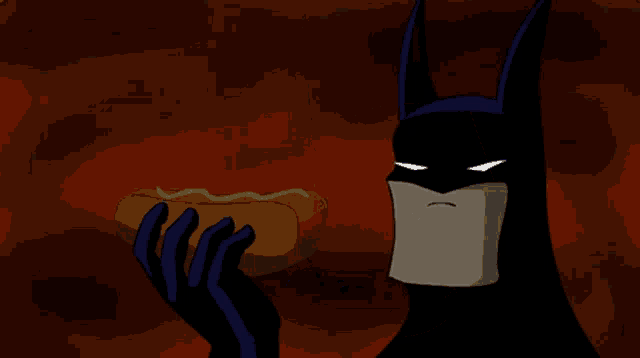a cartoon batman eating a hot dog with his mouth open