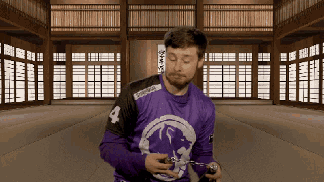 a man in a purple shirt with the number 4 on the front