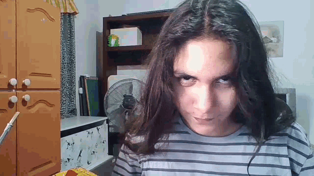 a woman with long hair is wearing a striped shirt that says replay on the front