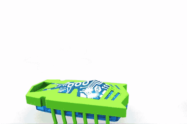a green toy with a circuit board on it is next to a pink toy