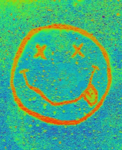 a drawing of a smiley face with crossed eyes and a tongue sticking out .