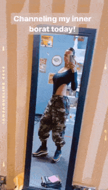 a woman taking a selfie in front of a mirror with the words channeling my inner borat today