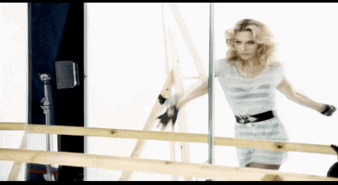 a woman is standing in front of a mirror looking at herself