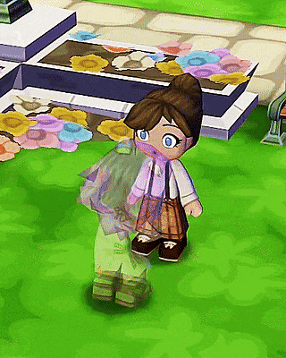 a little girl with a scarf around her neck is standing on a grassy field