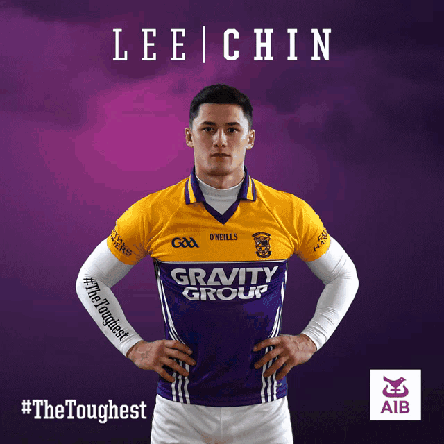 a man wearing a purple and yellow jersey with the word gravity group on it