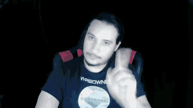 a man wearing a t-shirt that says wasowned on it