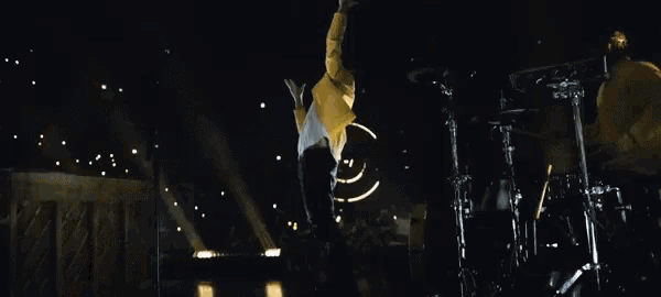 a basketball hoop is lit up in the dark with a yellow light