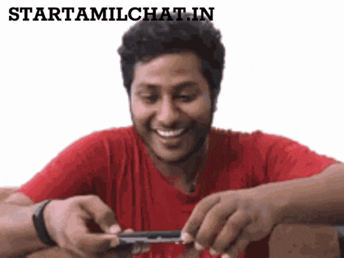 a man in a red shirt is smiling while rolling a cigarette with the words starttamilchat.in above him