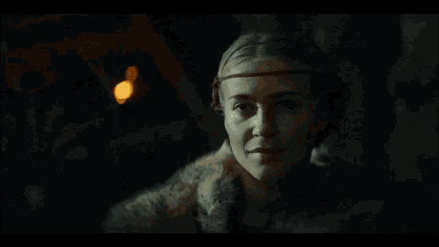 a man and a woman are looking at each other in front of a fire