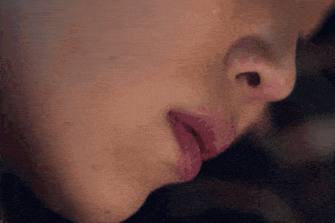 a close up of a woman 's mouth with pink lipstick on