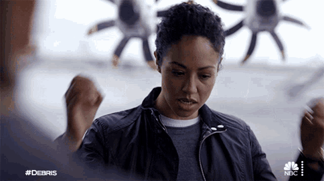 a woman in a black jacket with the hashtag #debris on the bottom right