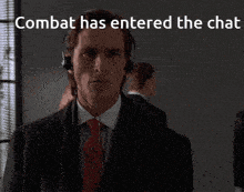 a man in a suit and tie is wearing headphones and the words combat has entered the chat