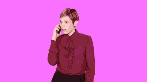 a woman in a red ruffled shirt is looking at her cell phone