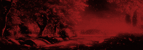 a red background with trees and a bridge in the background