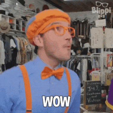 a man in a blue shirt and orange suspenders is saying wow