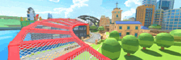 a red bridge over a body of water in a city