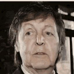 a close up of a man 's face with a blurred background .