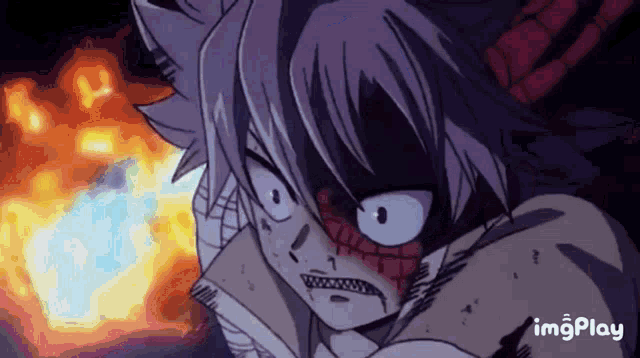 a close up of a person 's face with fire in the background