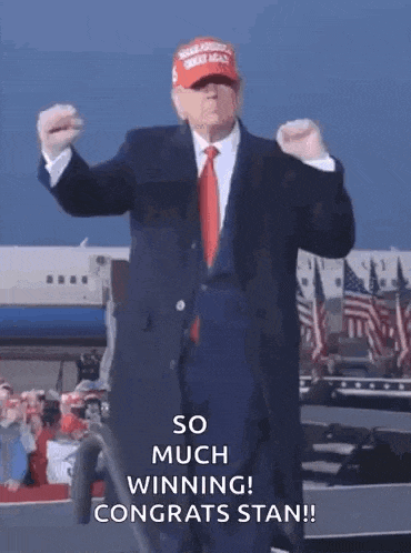 a man in a suit and tie is wearing a maga hat
