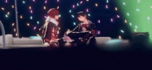 a blurry picture of two people standing next to each other in a dark room
