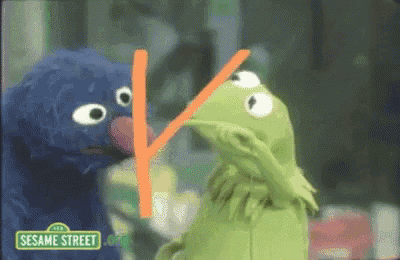 two sesame street characters are standing next to each other
