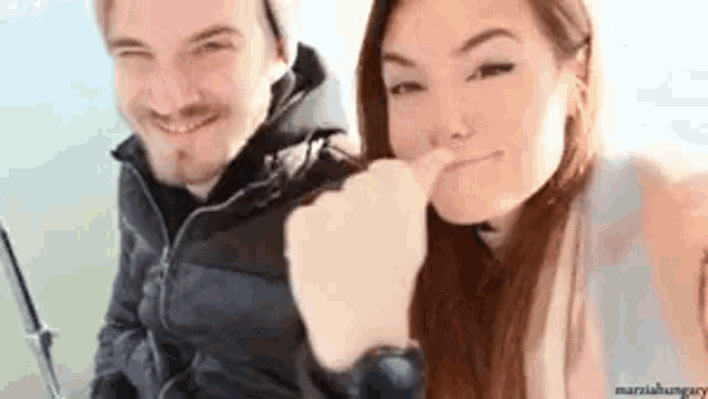 a man and a woman are sitting next to each other on a boat .