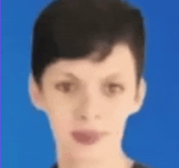 a blurry picture of a young man 's face with a blue background .