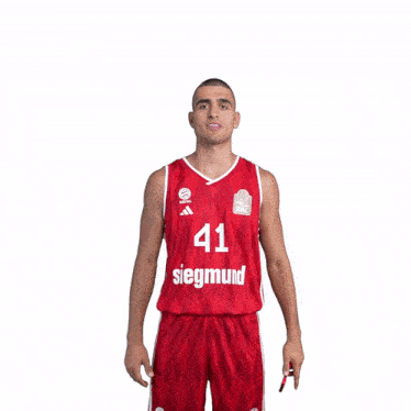 a man wearing a red siegmund jersey stands in front of a white background