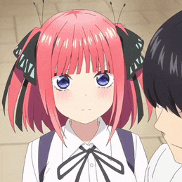 a girl with pink hair and blue eyes is standing next to a man with black hair .