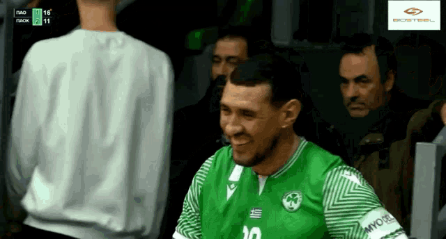 a man in a green and white jersey with the number 10 on it