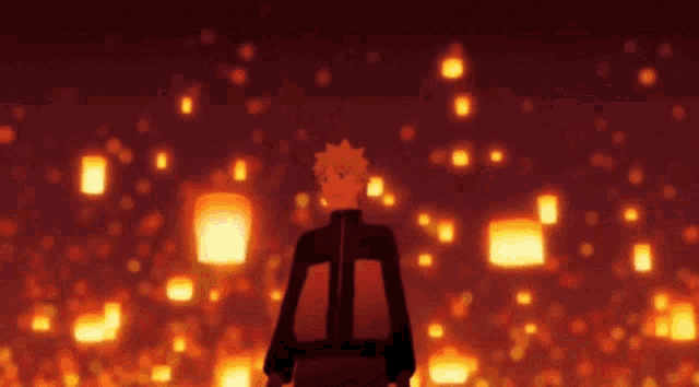 a man stands in front of a bunch of lanterns in the dark