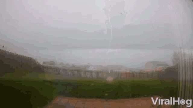 a lightning bolt is visible through a window with viralhog written on the bottom right