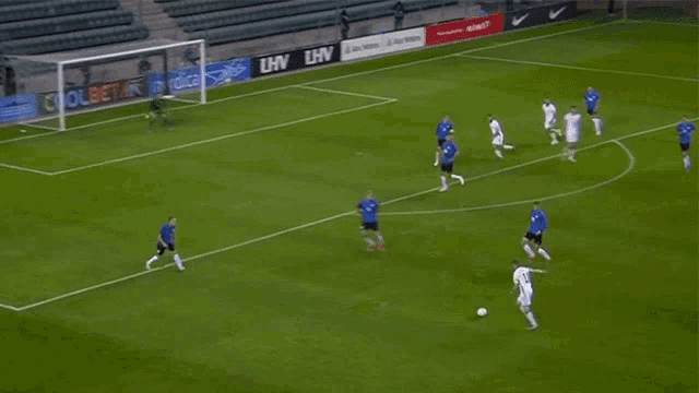 a soccer game is being played in front of a banner that says lhv on it