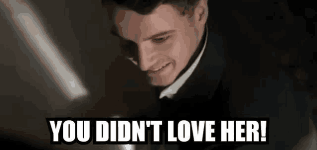 a man in a suit and tie is smiling and says `` you didn 't love her ! ''