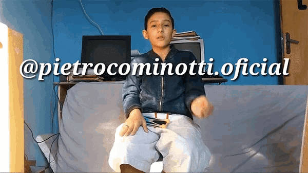 a boy is sitting on a couch with the words @ pietrocominotti.oficial written on the bottom