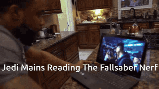 a person is reading the fall saber nerf on a laptop computer