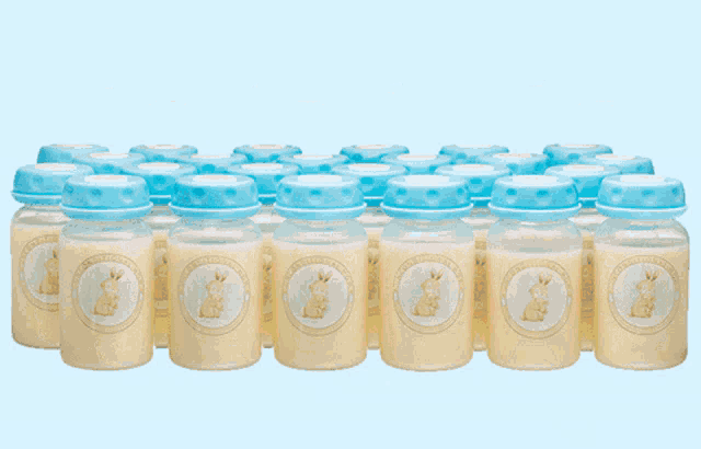 a row of bottles that say ' conventional milk ' on the front