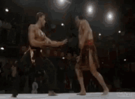 a man is kneeling down next to a woman in a ring .