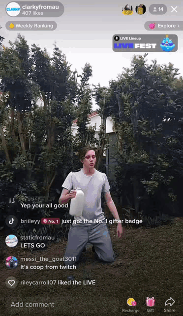 a man is kneeling down holding a bottle in front of trees and a live fest logo