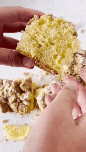 a person is holding a piece of cake in their hands