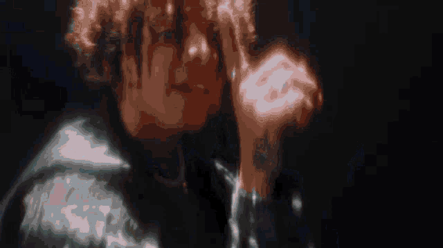 a close up of a person 's face with a blurred image of their face