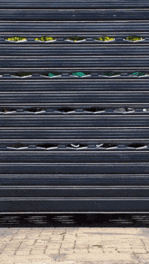 a close up of a black roller shutter with holes in it