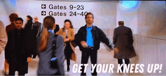 a group of people are dancing in front of a sign that says gates 9-23