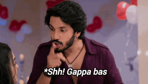 a man with a beard is pointing at a woman and saying shh ! gappa bas .