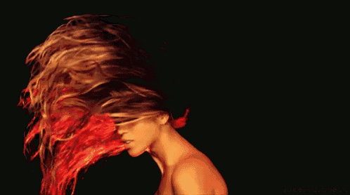 a woman 's hair is being blown by the wind and the words queen ratcheto are visible in the corner