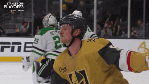 a hockey player in a stanley cup playoffs jersey stands on the ice