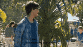 a man in a blue plaid shirt is standing in front of a palm tree and says no one me rambling about history